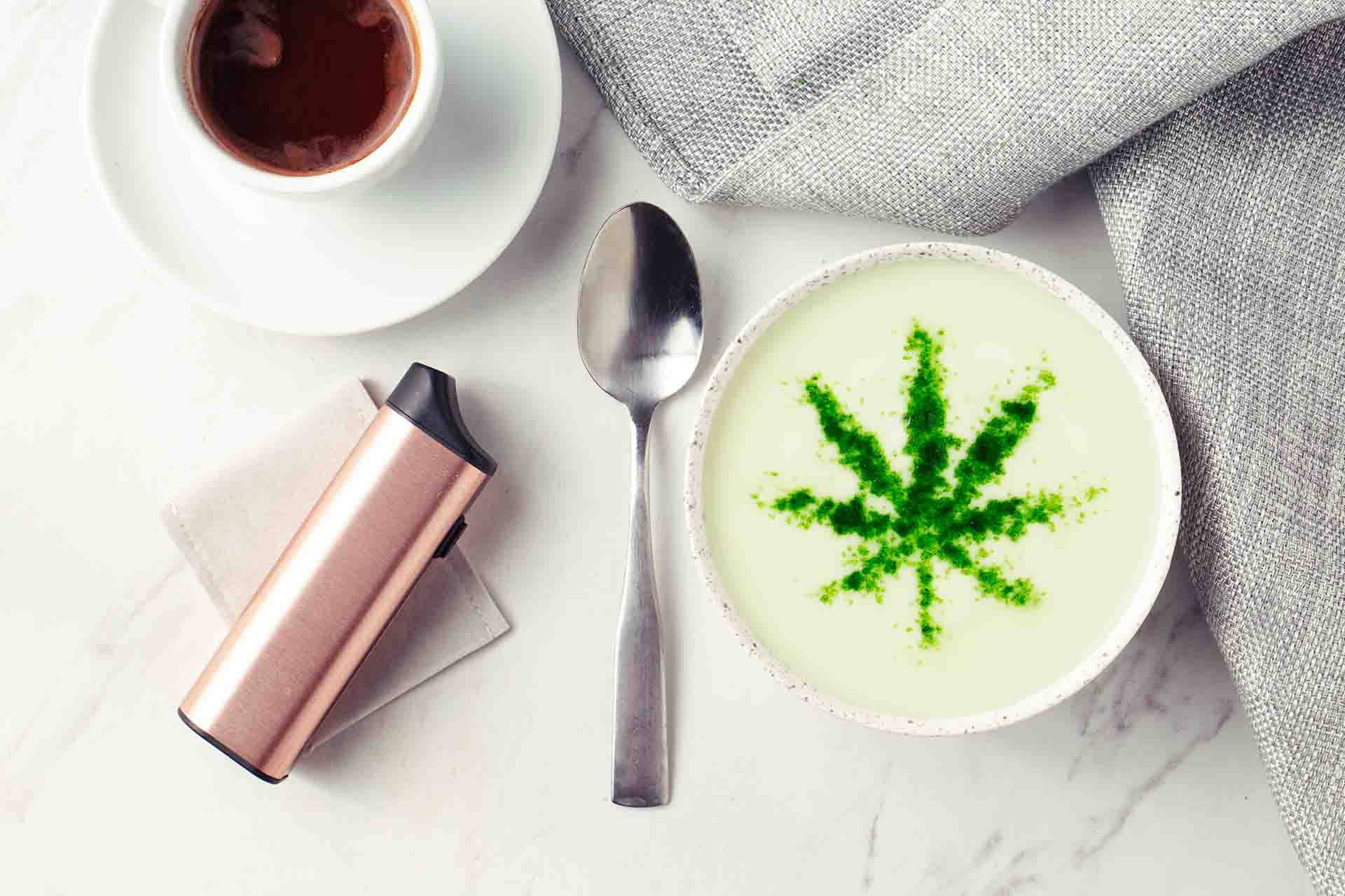 Table with CBD coffee and CBD vape on top (image)